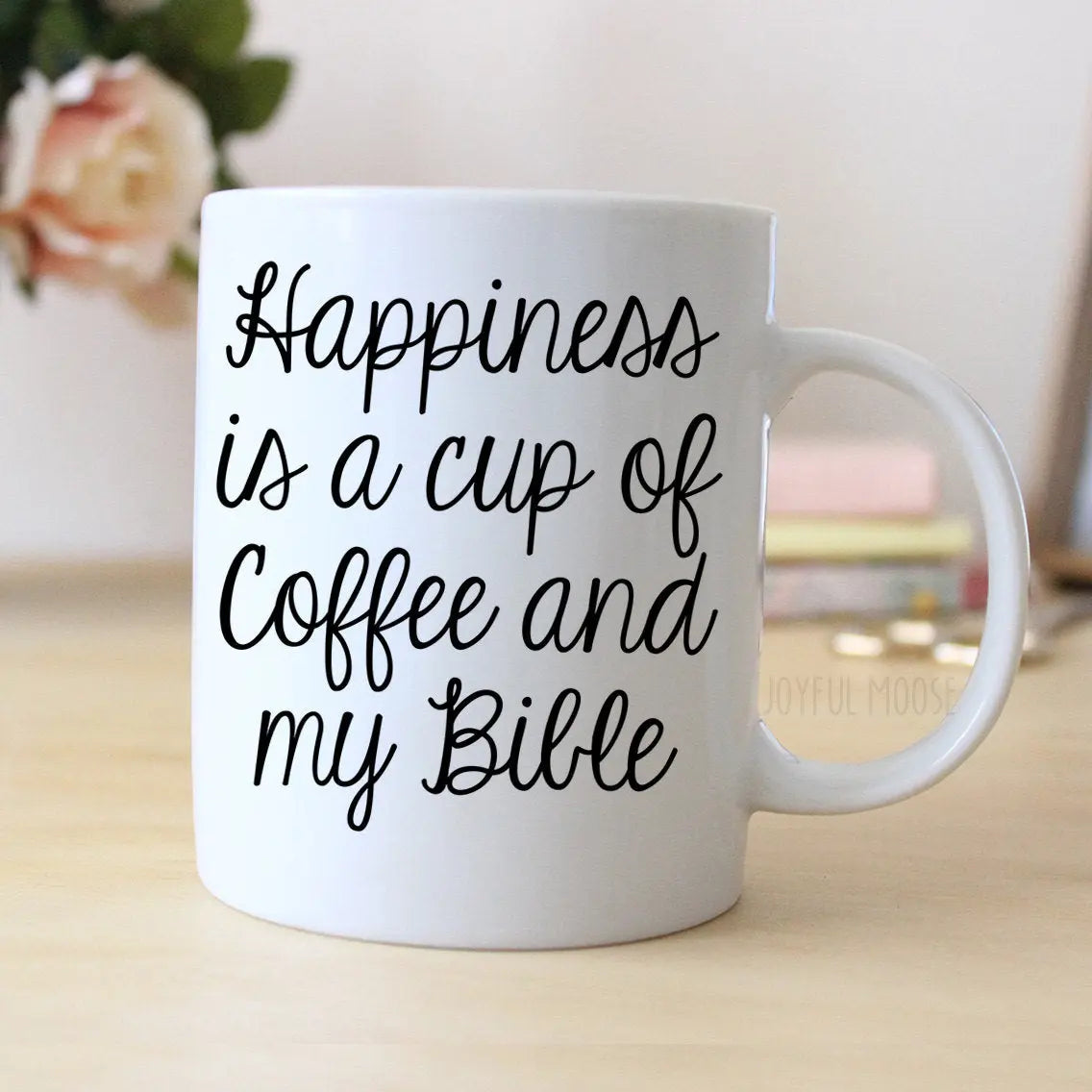 White ceramic coffee mug with handle, black script: 'Happiness is a cup of coffee and my Bible'