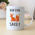 White coffee mug with orange fox graphic and "OH! FOR SAKE!" text
