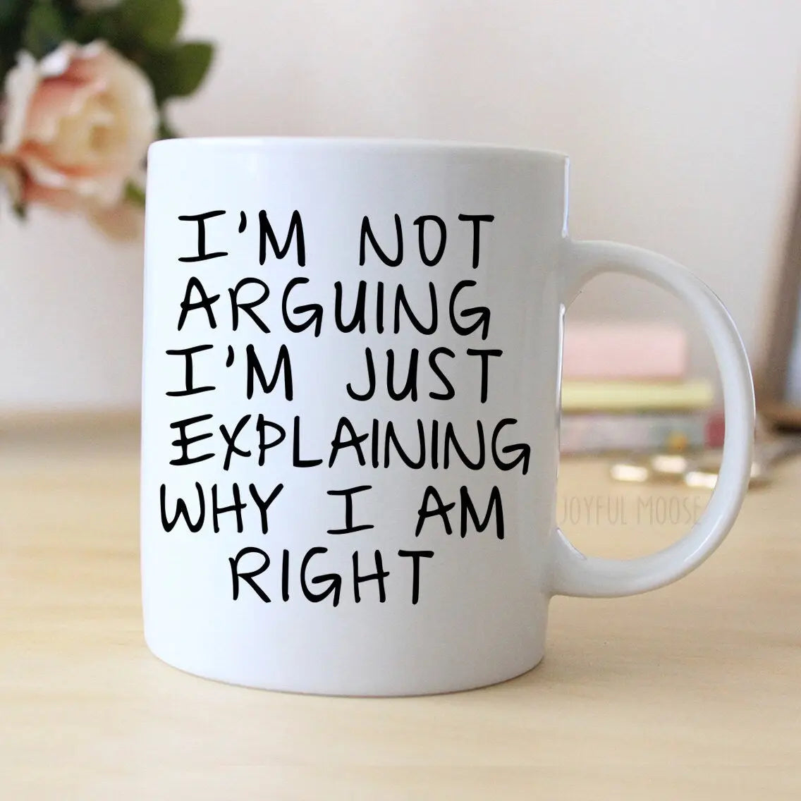 White ceramic coffee mug with large black quote text, side view