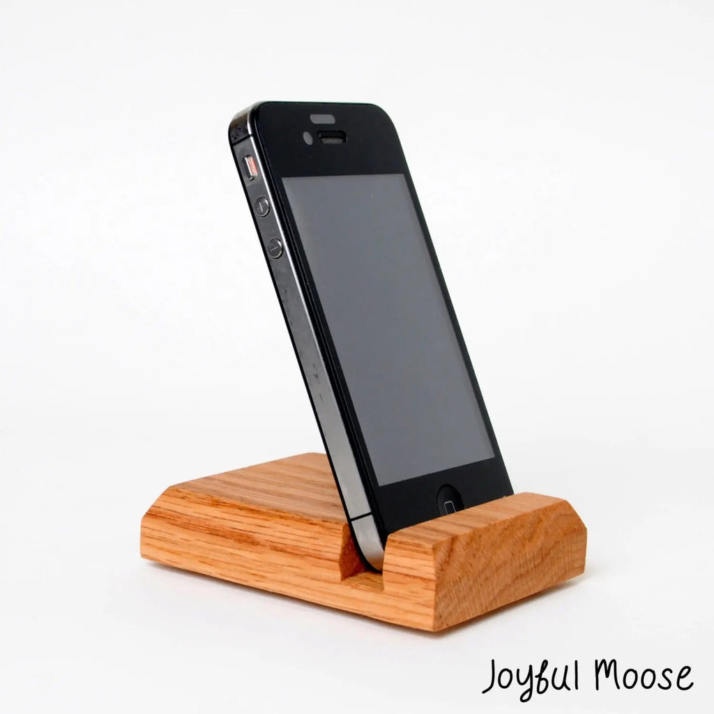 Wooden iPhone holder stand with phone docked at an angle