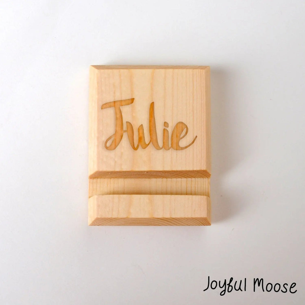 Wooden iPhone stand with engraved "Julie" name on front panel