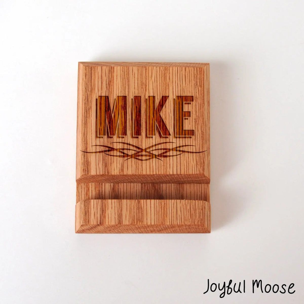 Engraved wood phone docking station block with decorative name line on front face
