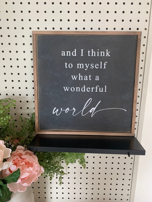 Framed wood sign with dark slate insert and white script quote, including “wonderful world”