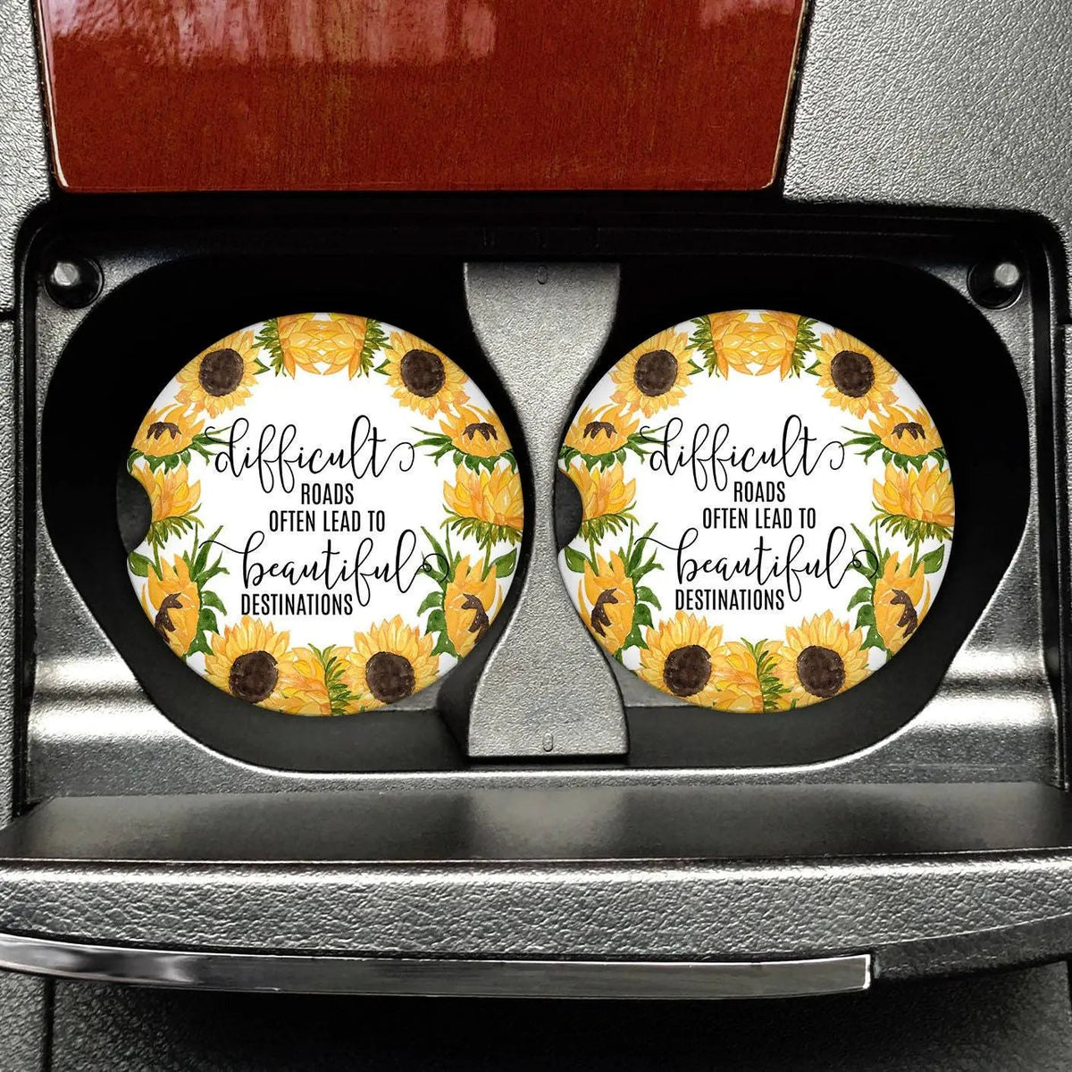 Set of 2 round car coasters with black rims, sunflower artwork and inspirational text