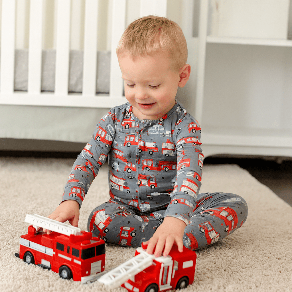 Boys convertible romper in gray-blue with red bus and car print, long sleeves and snaps at legs