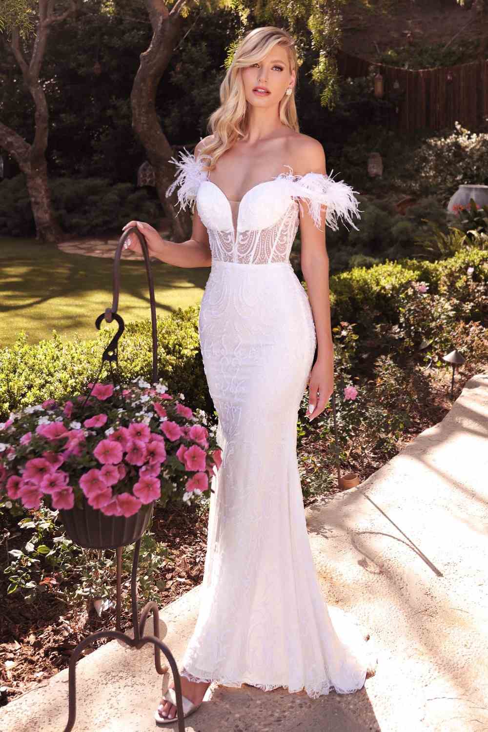 Off-white bridal gown with off-shoulder neckline, feather trim, and fitted flowing skirt
