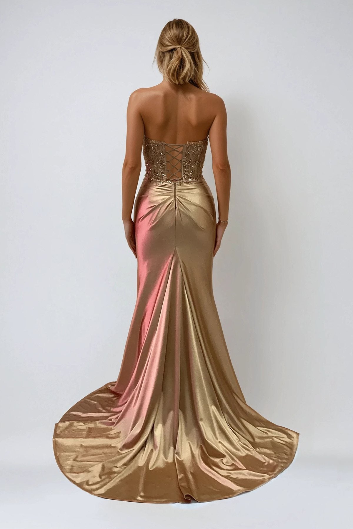 Back view of beaded strapless prom gown in ombré pink-to-gold satin with ruched waist