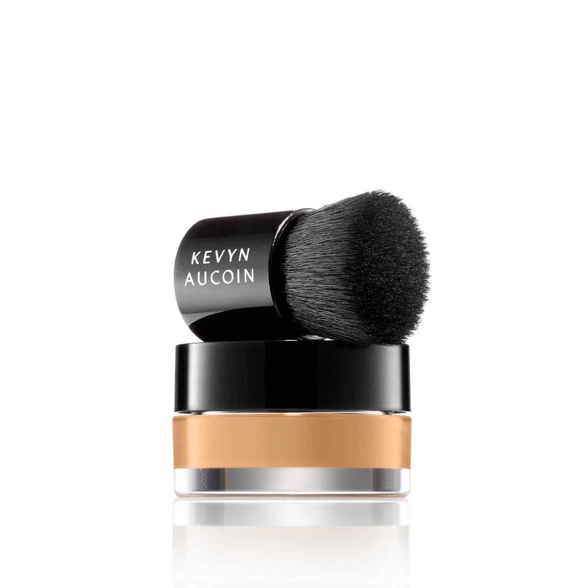 Mini foundation balm with black brush applicator and beige balm layer