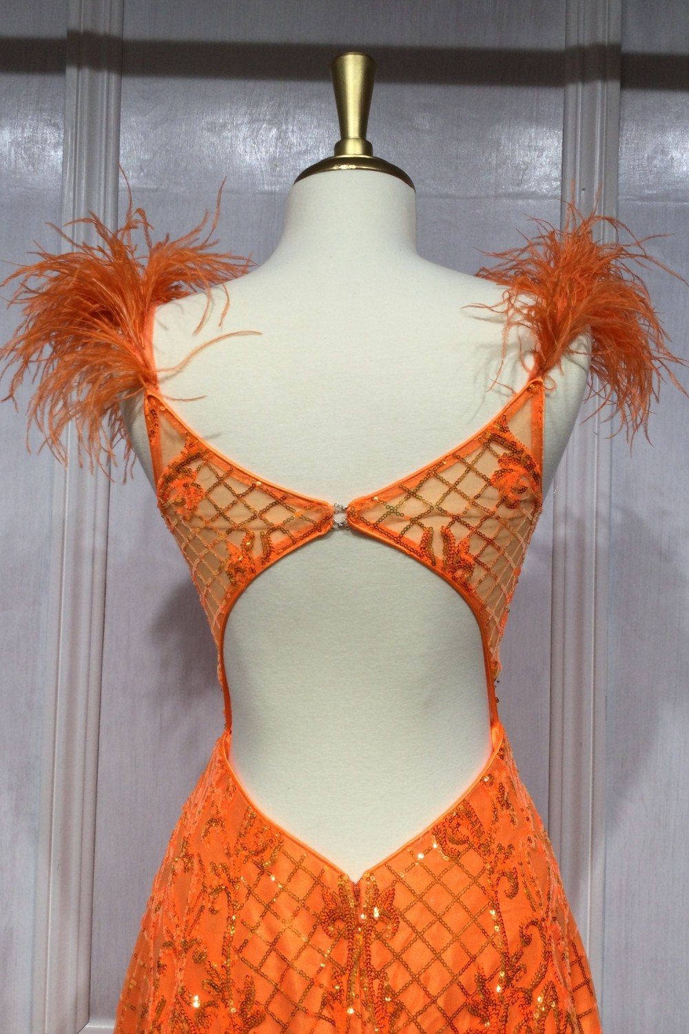 Neon orange sequin floor-length gown with feather-trimmed strappy neckline