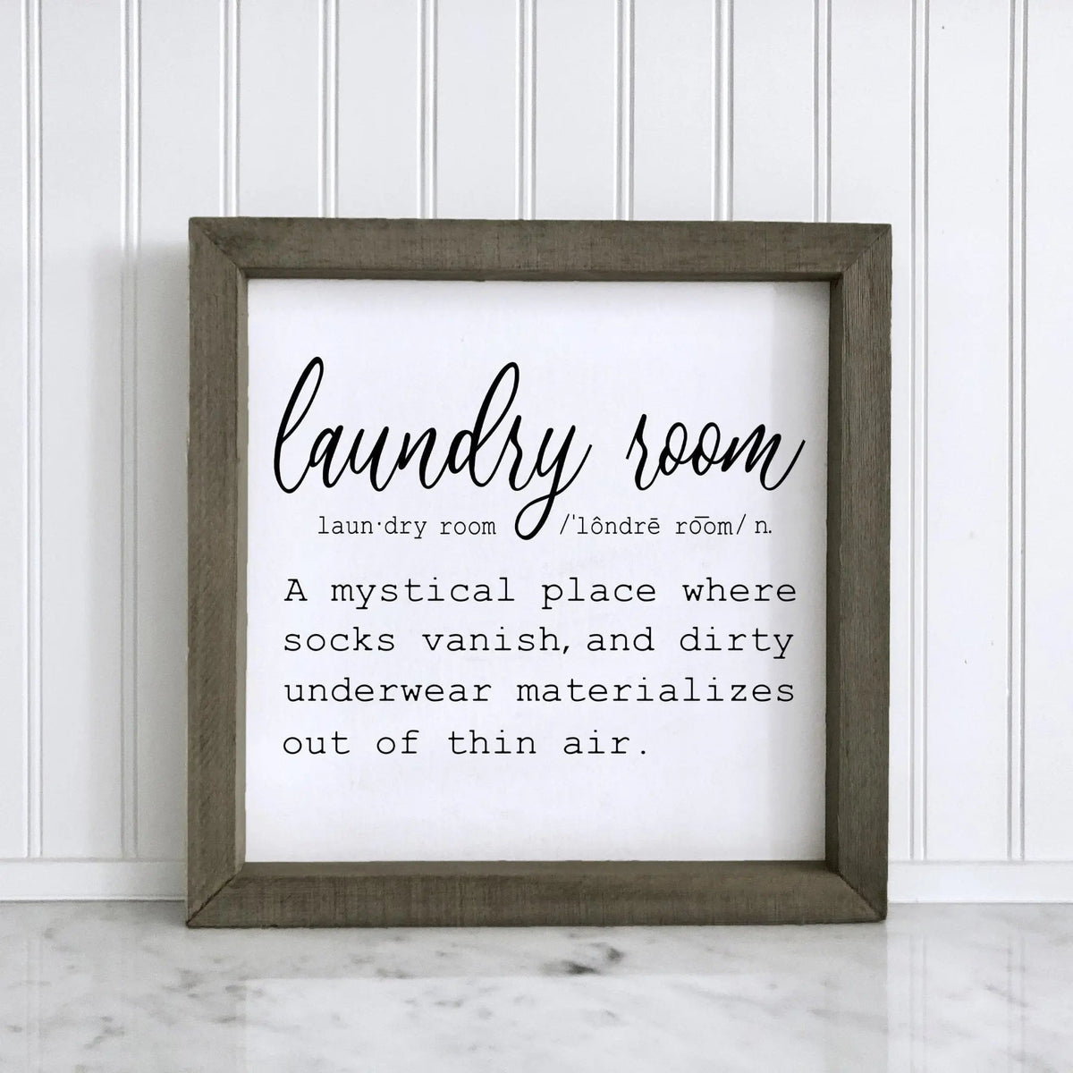 Framed laundry room wall sign with dark gray border, script text “laundry room!”