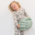 Light gray kids pajama set with green dinosaur print, long-sleeve top and pants