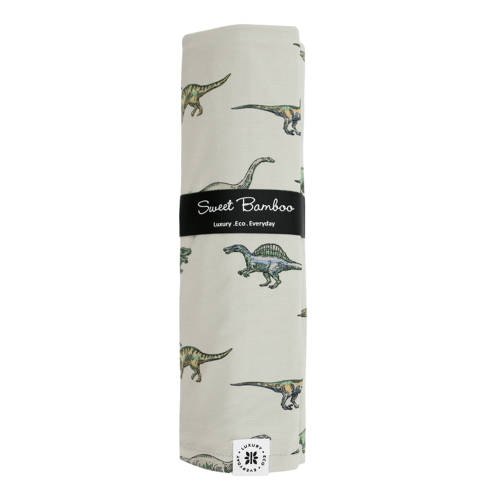 Sweet Bamboo swaddle blanket roll in cream with green dinosaur print