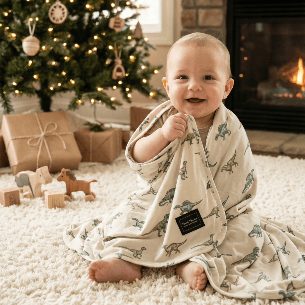 Baby swaddle blanket in cream with green dinosaur pattern, soft hooded wrap