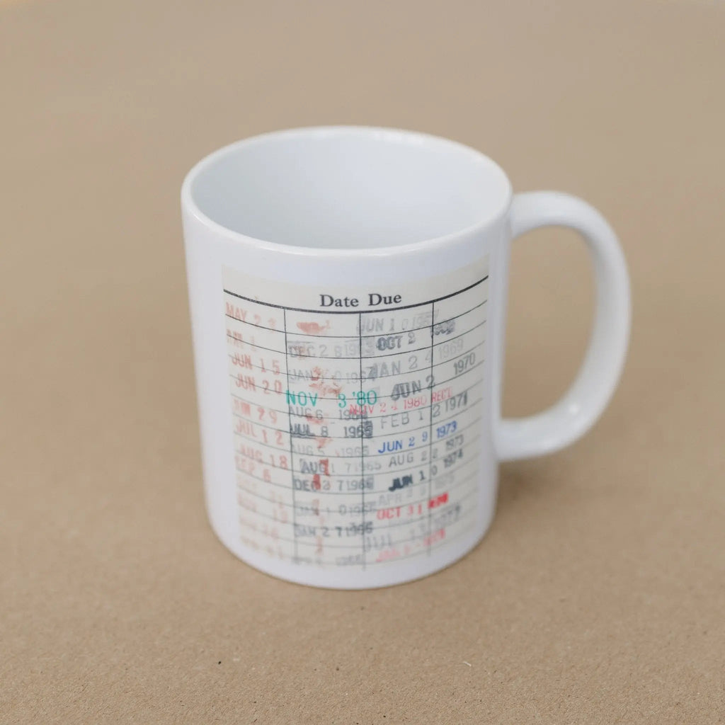 White coffee mug with date-due calendar print, side view with handle