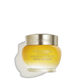 L'Occitane Immortelle cream jar with gold lid and amber glass