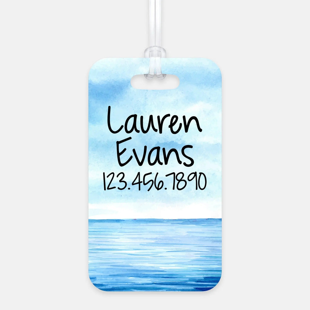Rounded rectangle luggage tag with Lauren Evans and 123.456.7890 over blue ocean waves