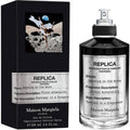 Maison Margiela Replica eau de parfum bottle, black cap, and boxed label
