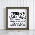 Personalized wood framed sign reading "ANDREW'S MAN CAVE" and "BEER IS ALWAYS COLD"