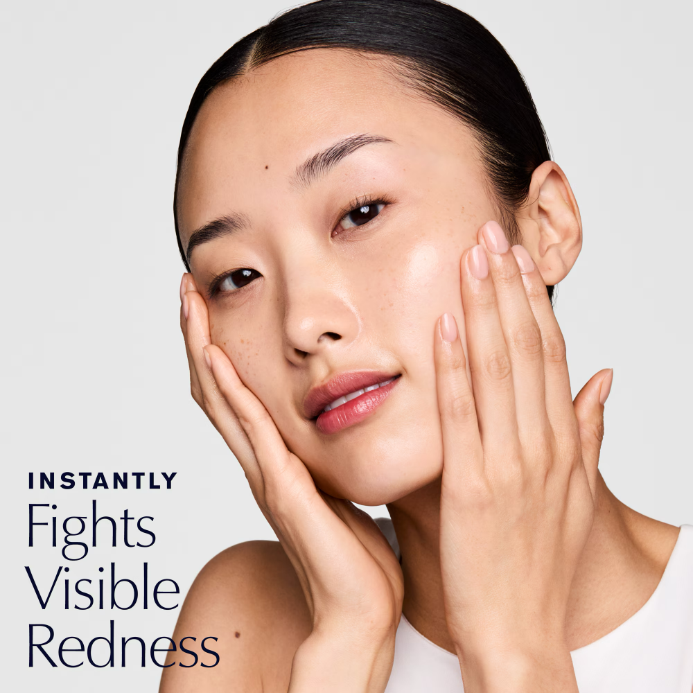 Facial skincare toner lotion application on cheek and temple with hands.
