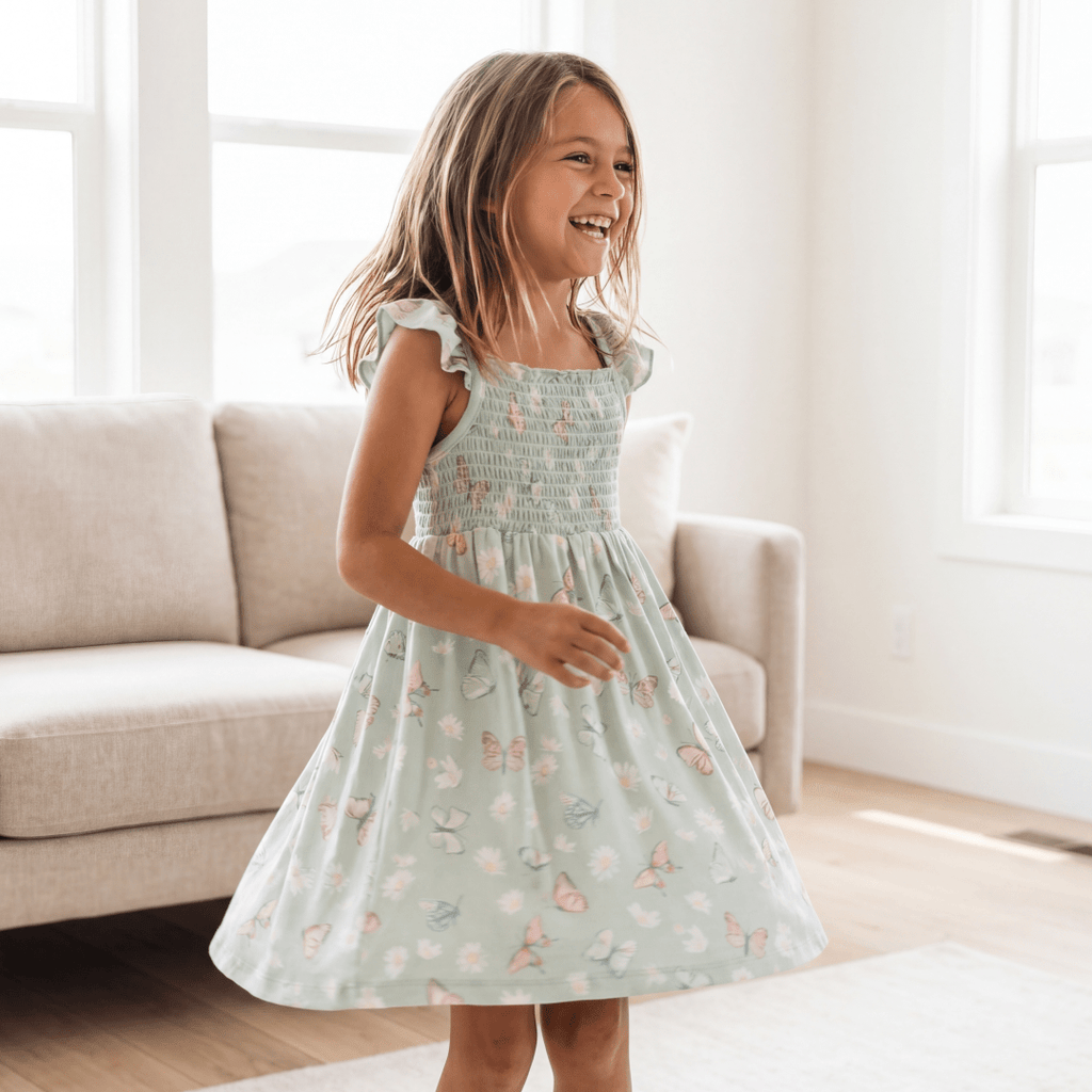 Girl's mint smocked dress with butterfly print, flutter sleeves and gathered skirt