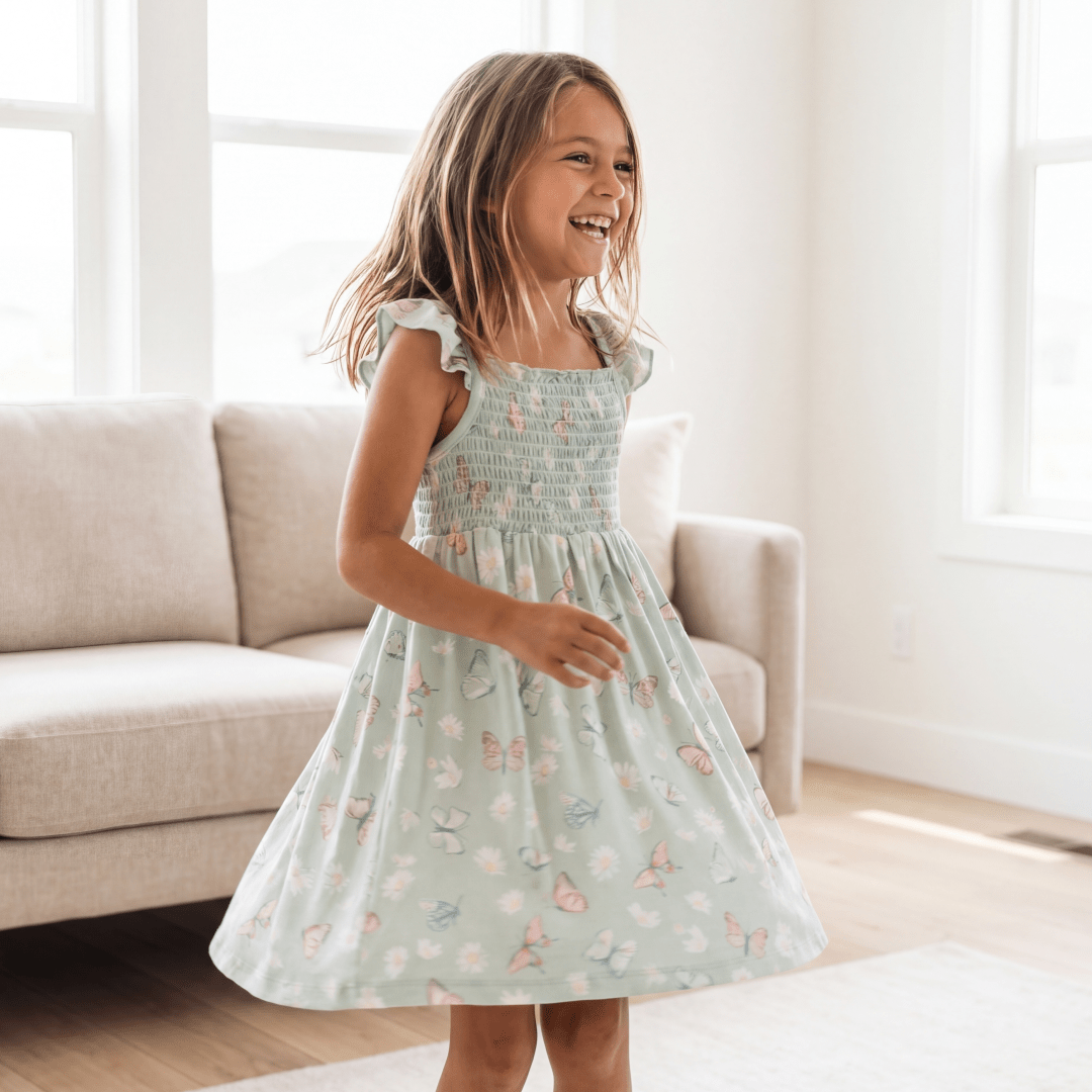 Girl's mint smocked dress with butterfly print, flutter sleeves and gathered skirt