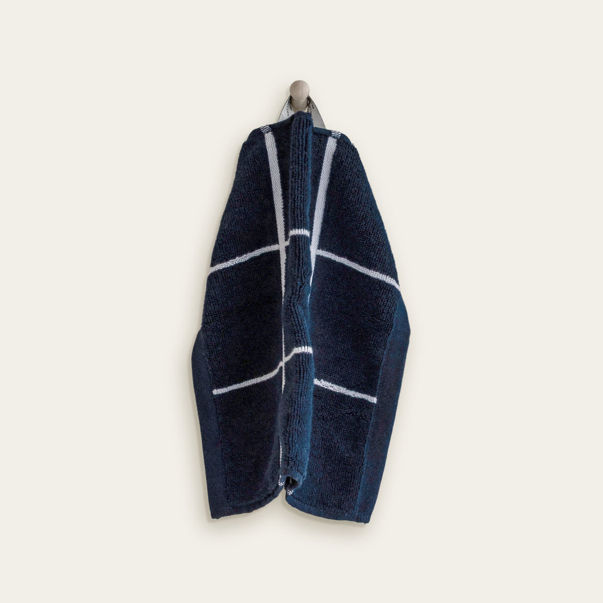 Hanging navy cotton towel with thick white grid stripes
