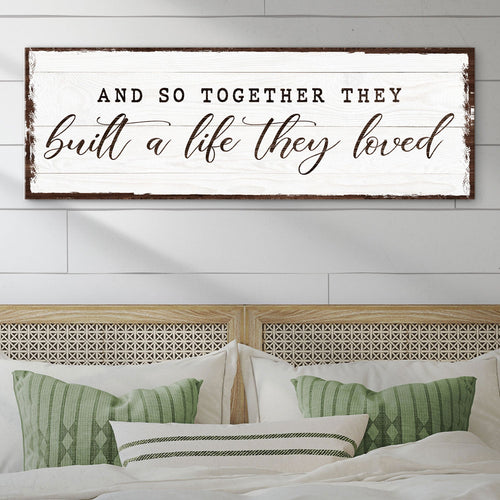 Framed wall sign with quote: “build a life they loved” in black cursive
