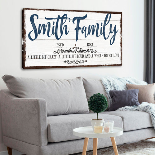 Family wall sign with blue cursive “Smith Family” and love quote underneath