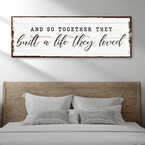 Framed wall sign with quote text “built a life they loved” on a light background