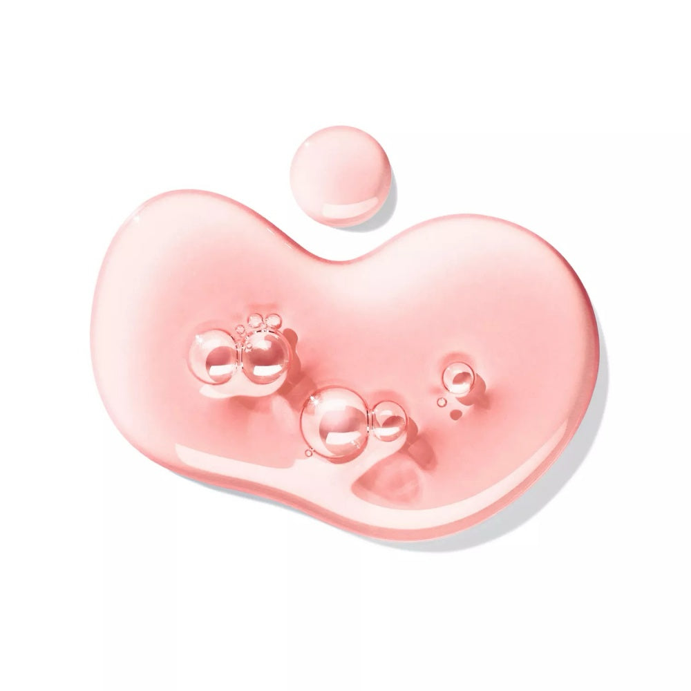 Pink heart-shaped bath gel with floating bubbles and small decorative icons