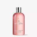 Molton Brown rhubarb & rose bath and shower gel bottle, pink with silver cap