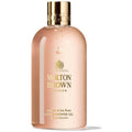 Bath & shower gel bottle, jasmine & sun rose scent, peach-pink with gold cap.