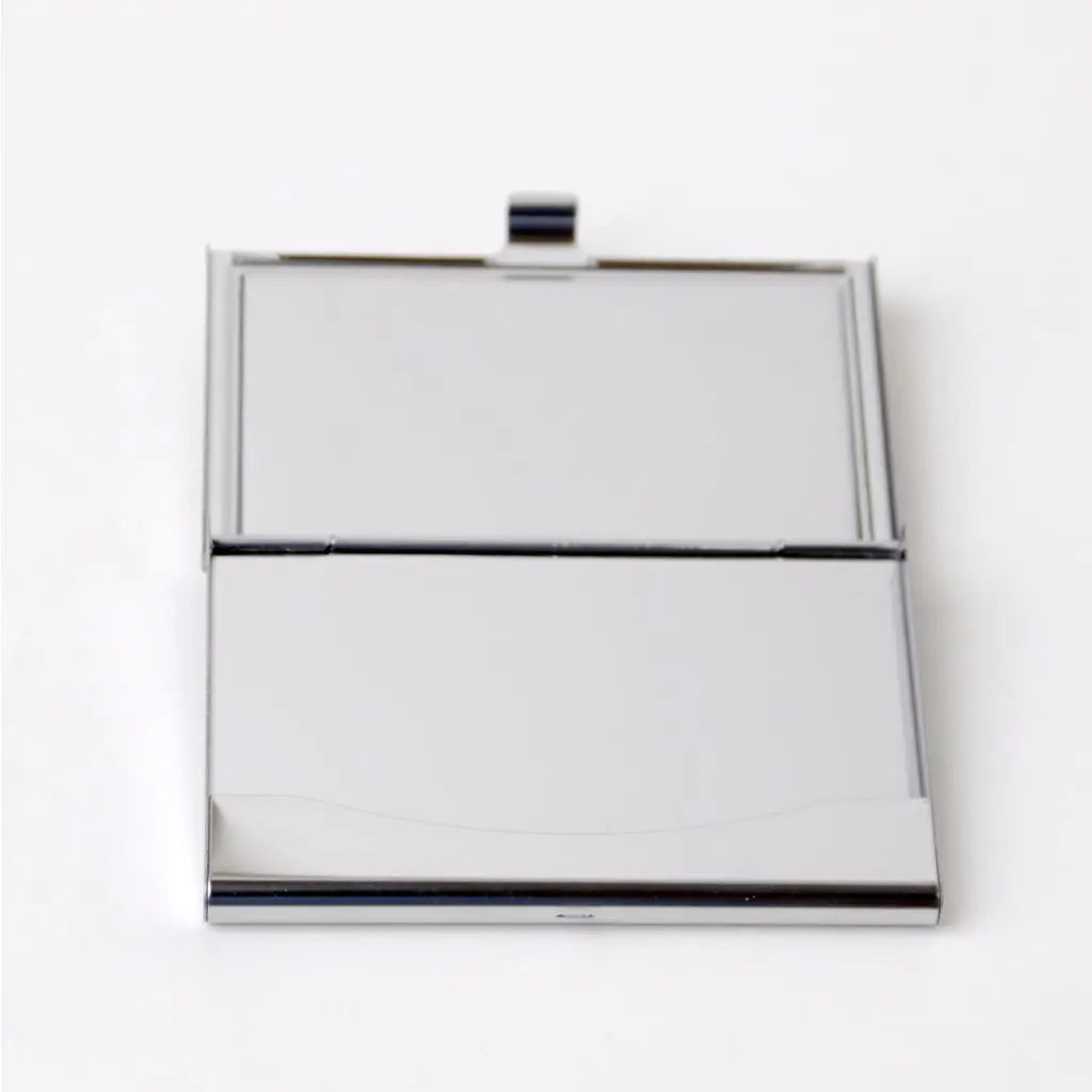 Metal business card holder with open lid and blank interior, silver finish
