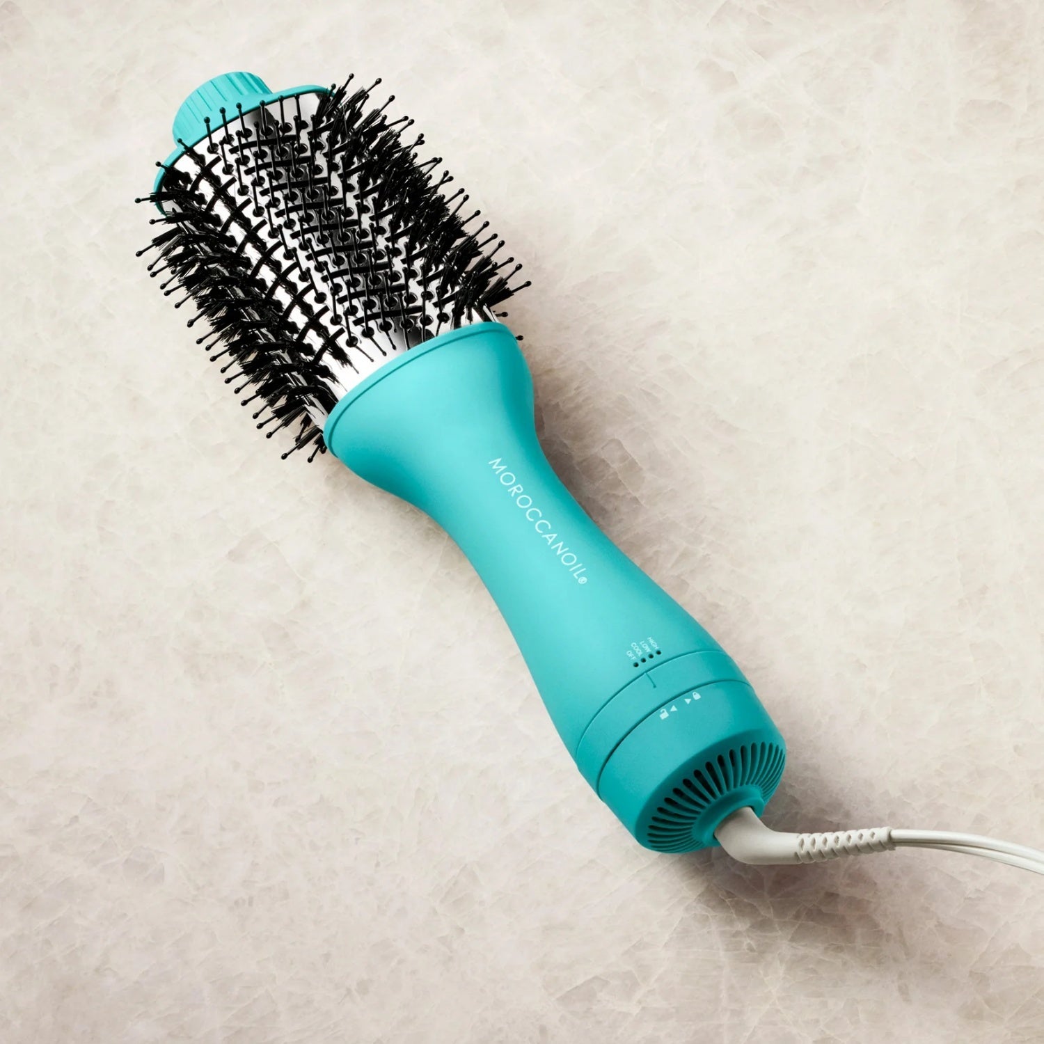 Moroccanoil teal blow-dryer brush with round black bristles and power cord