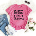 Pink unisex t-shirt with 'My favorite people call me Grandma' graphic