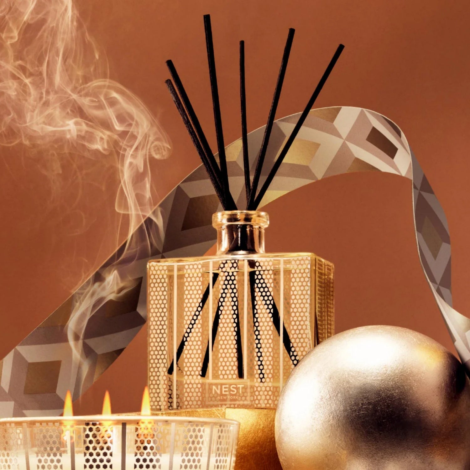 Amber & incense reed diffuser bottle with black reeds in textured glass holder