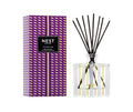 NEST reed diffuser with clear square glass bottle, black reeds, plum patterned box