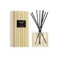 Reed diffuser with clear glass bottle, black reeds, and striped product box