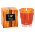 Pumpkin Chai scented candle with orange glass tumbler, lit flame, and patterned gift box