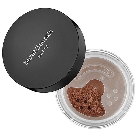 Matte foundation compact with black lid and open jar showing dark brown powder