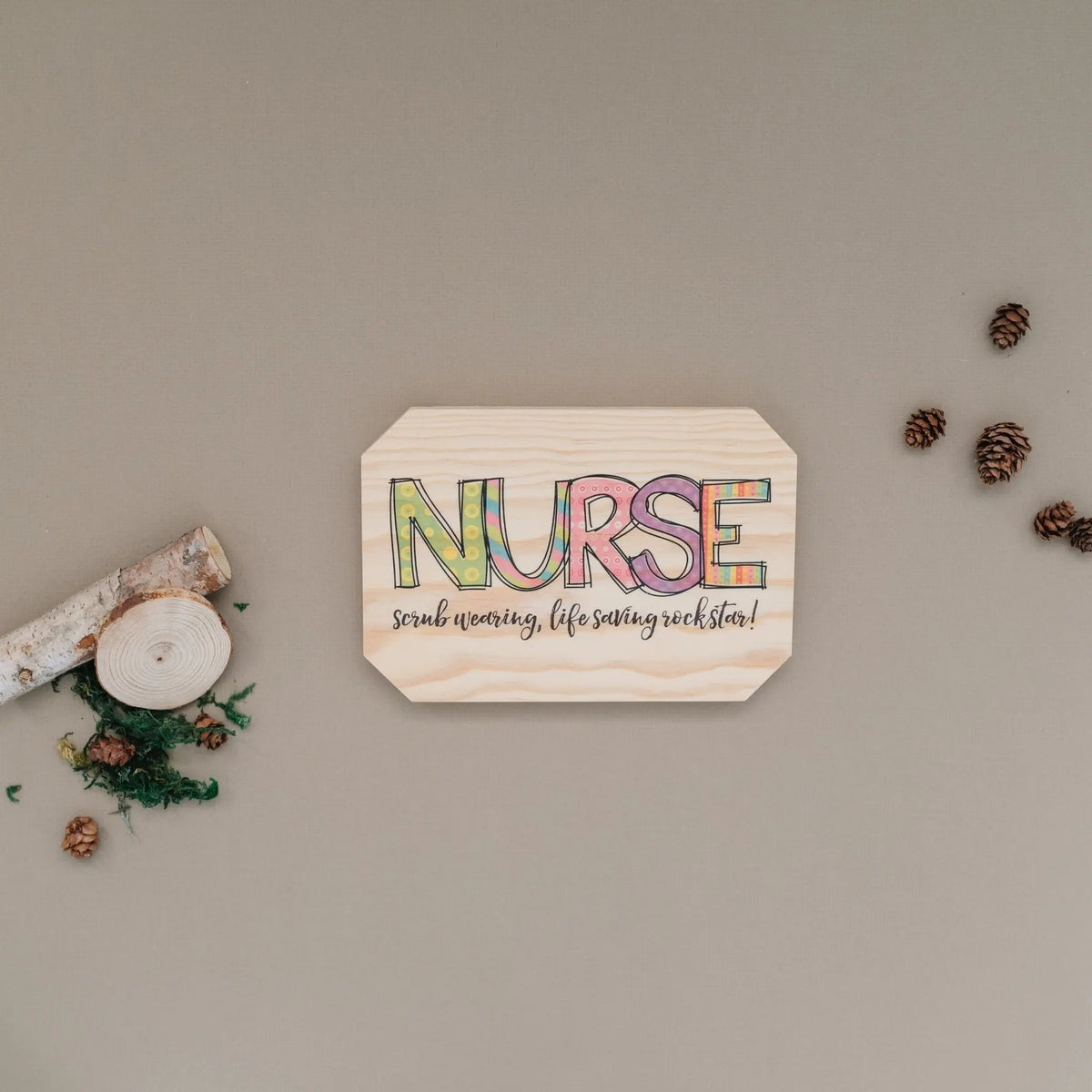 Nurse wooden wall sign with colorful 'NURSE' and 'rockstar' slogan, hexagon shape
