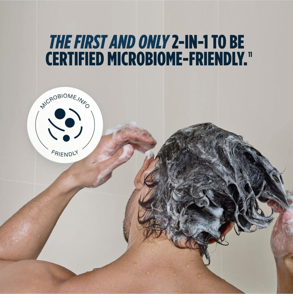 Lathered hair and scalp being washed under running water
