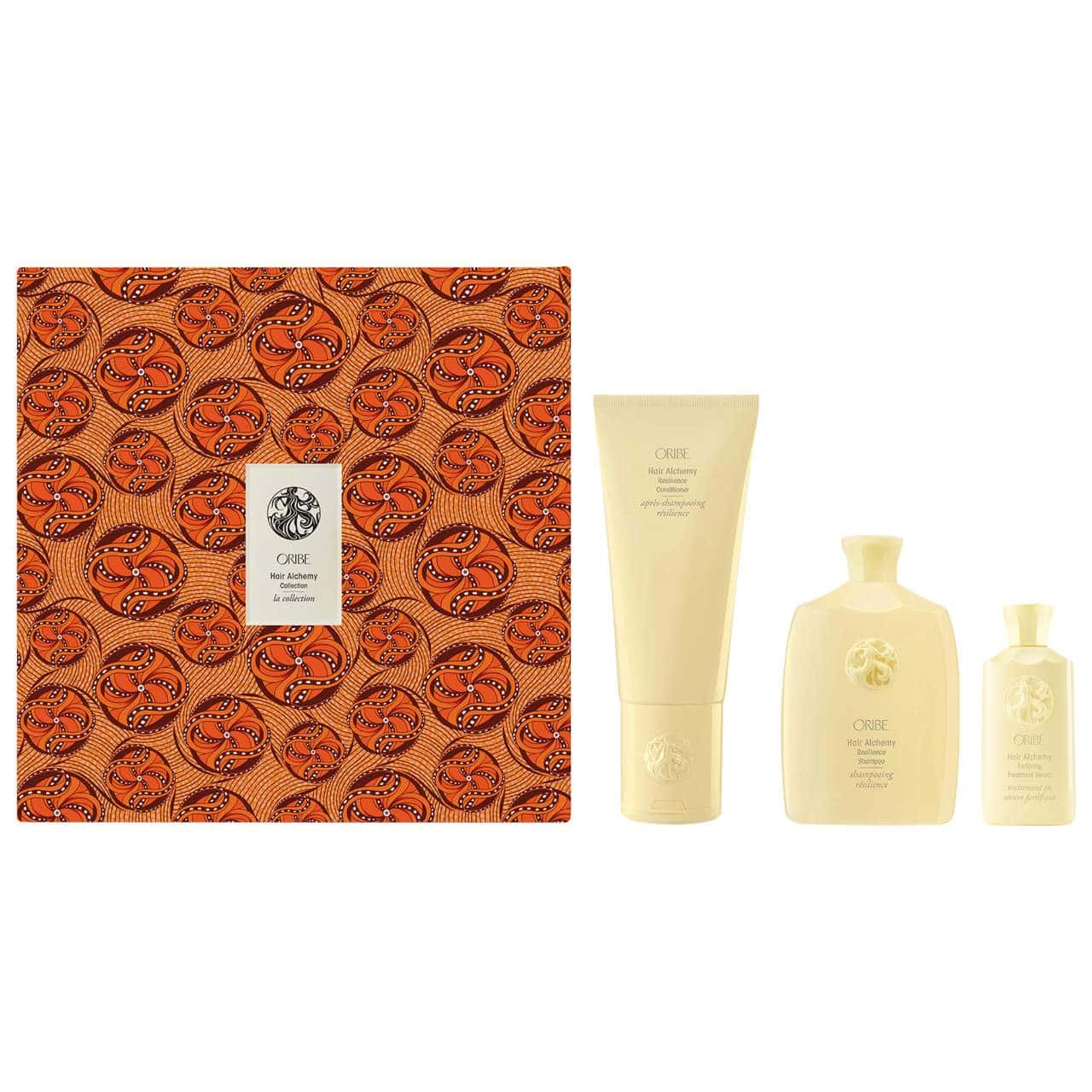 Hair care gift set with orange patterned box and lotion bottles, tubes, and pump