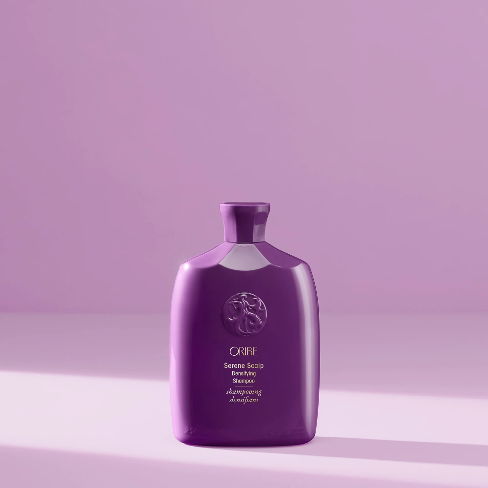 Shampoo bottle, small view in dark purple with ORIBE emblem on front
