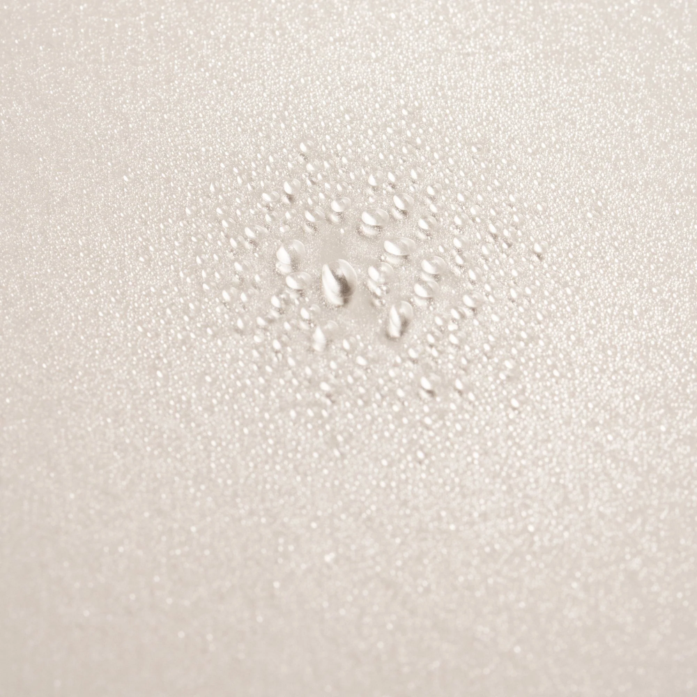 Scalp treatment spray droplets, clear liquid beads on skin