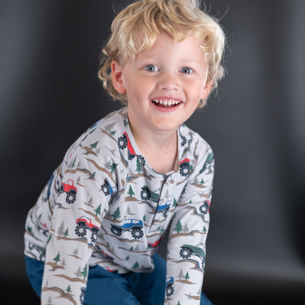 Boys raglan henley top in cream with colorful vehicle, tree and badge print, long sleeve