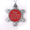 Baby's first Christmas ornament, silver snowflake frame, red center with 'Baby's First Christmas'