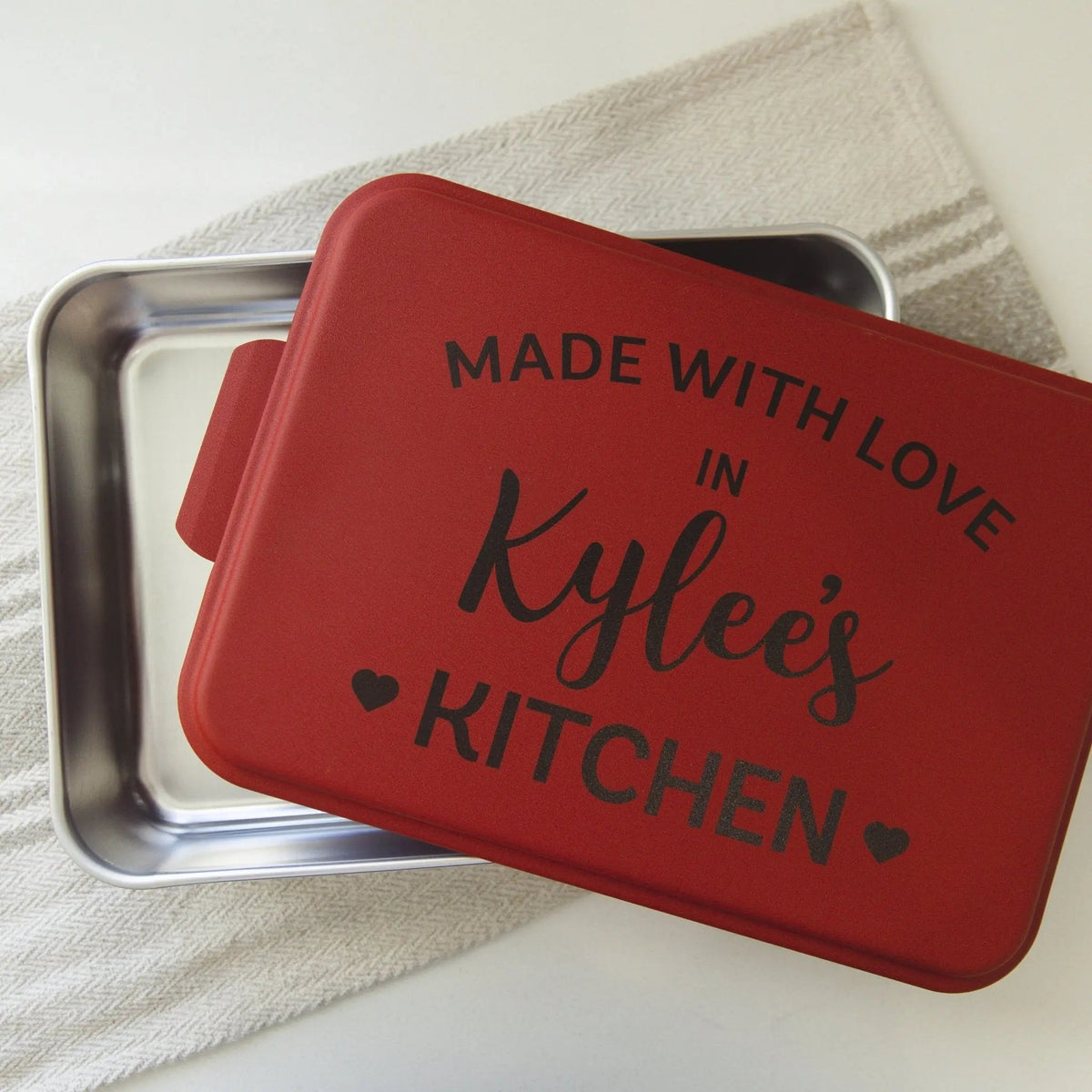 Red cake pan lid on metal bake tray, text: MADE WITH LOVE, Kylee's KITCHEN