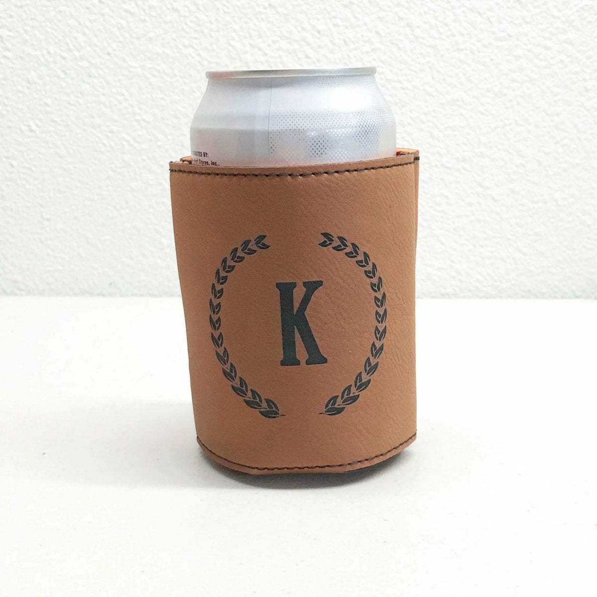 Brown personalized beer can cooler with engraved letter K and laurel wreath