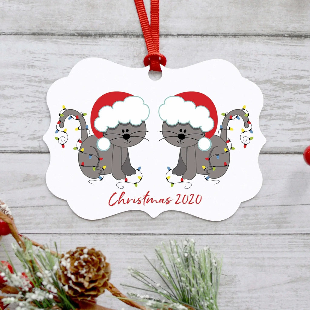 White hanging cat ornament with two gray cats wearing Santa hats and bells